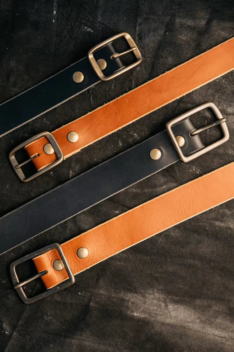 High-quality 8oz American Latigo leather belts in 1.5” width with brass buckles and rivet details.