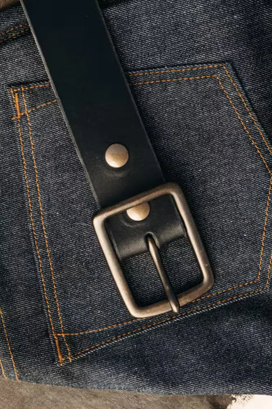 Latigo Belt in 1.7” width, crafted from 8oz American Latigo Leather, displayed over dark raw denim jeans with contrast stitching