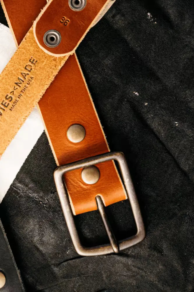 Latigo Belt in 1.7” width, in Sadle Latico color crafted from 8oz American Latigo leather, featuring a solid brass buckle on black fabric