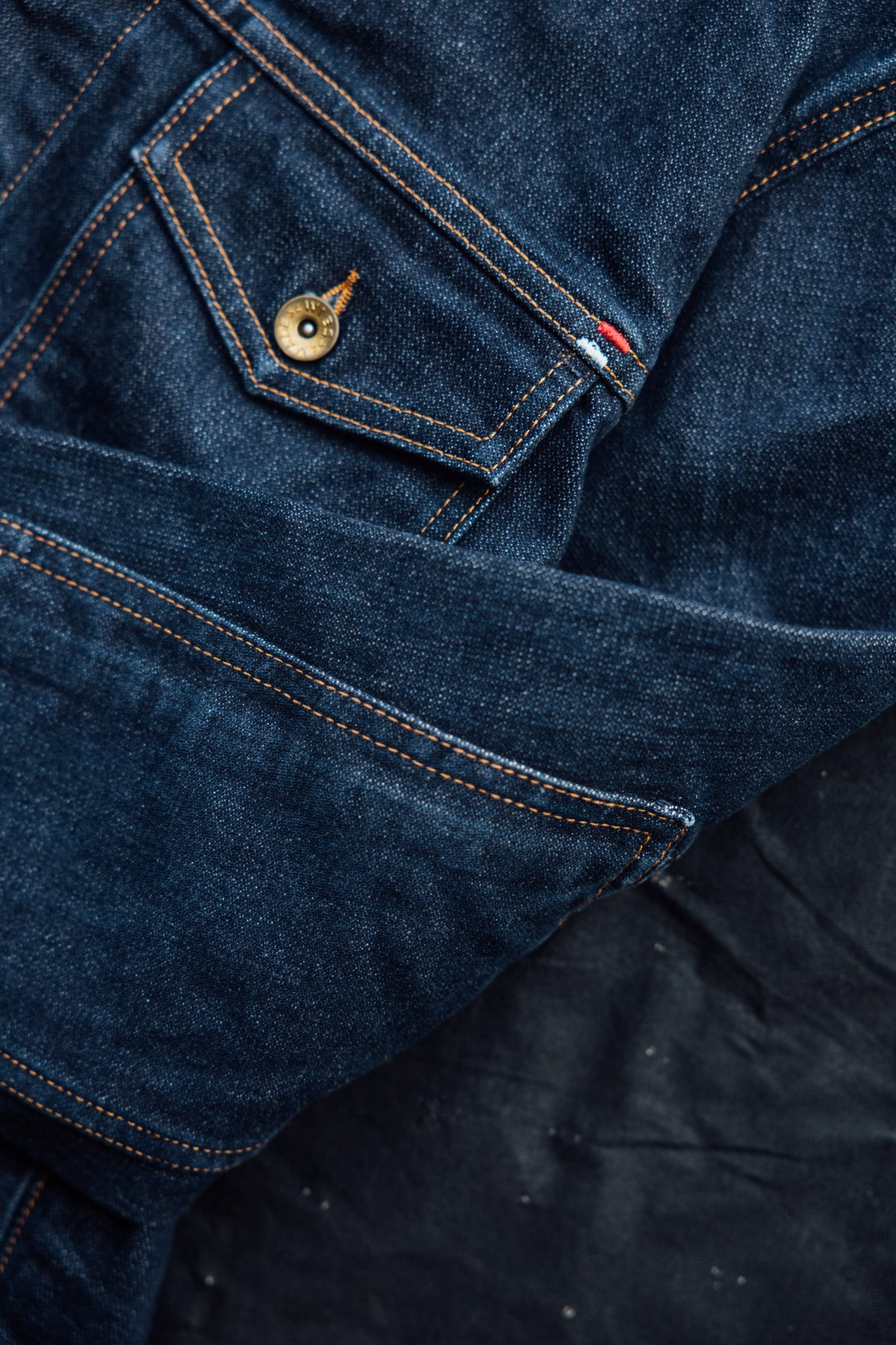 American made denim jacket close-up highlighting the chest pocket, contrast stitching, and quality craftsmanship.