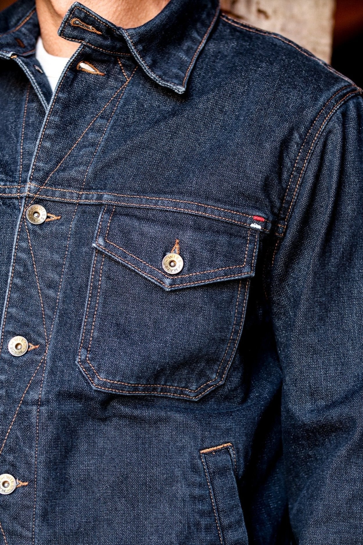 USA made denim jacket showcasing fine stitching, button details, and durable chest pocket construction.