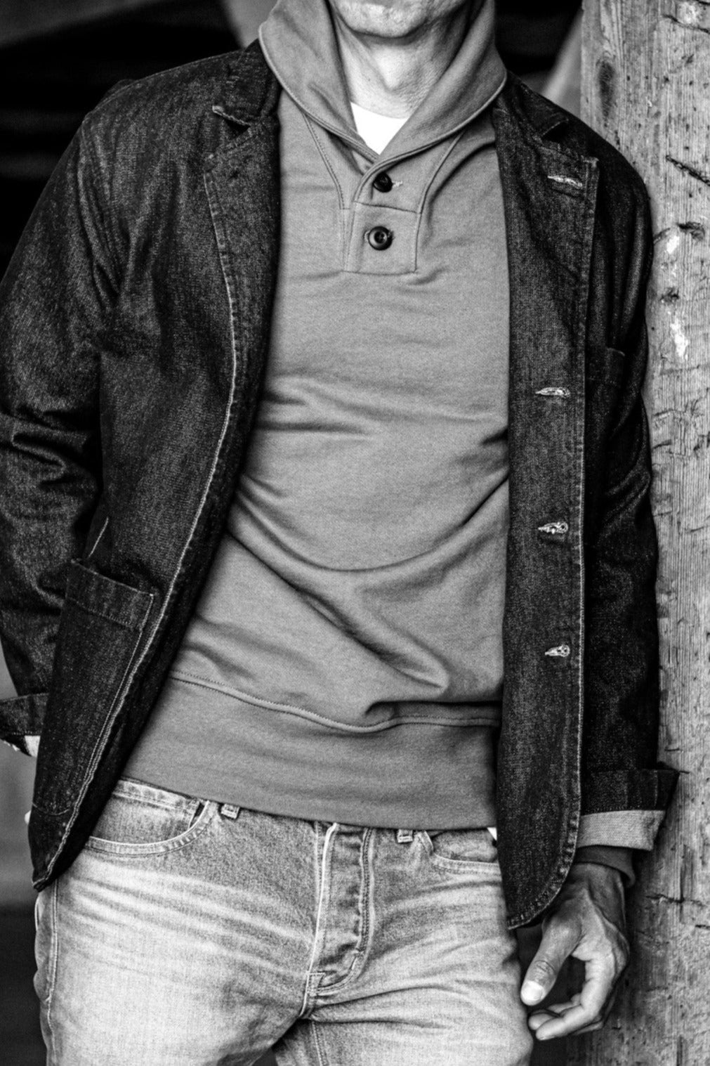 Men's cotton shawl collar cardigan layered under a denim jacket, paired with light-wash jeans for a rugged look.