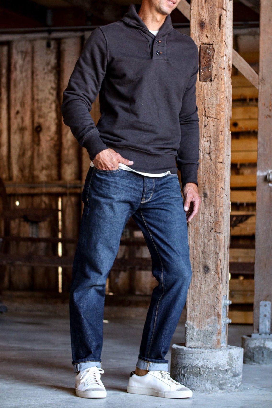 Shawl cardigan men style in black, paired with cuffed jeans and white sneakers for a casual, rustic look.