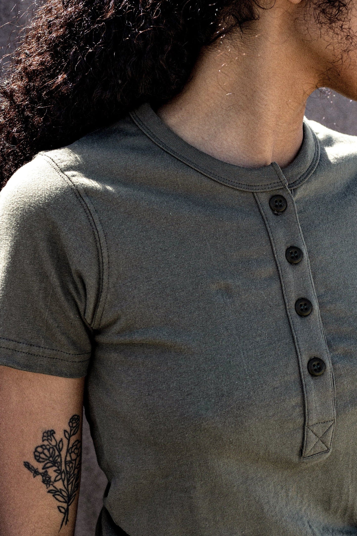 close up of a woman wearing henley olive