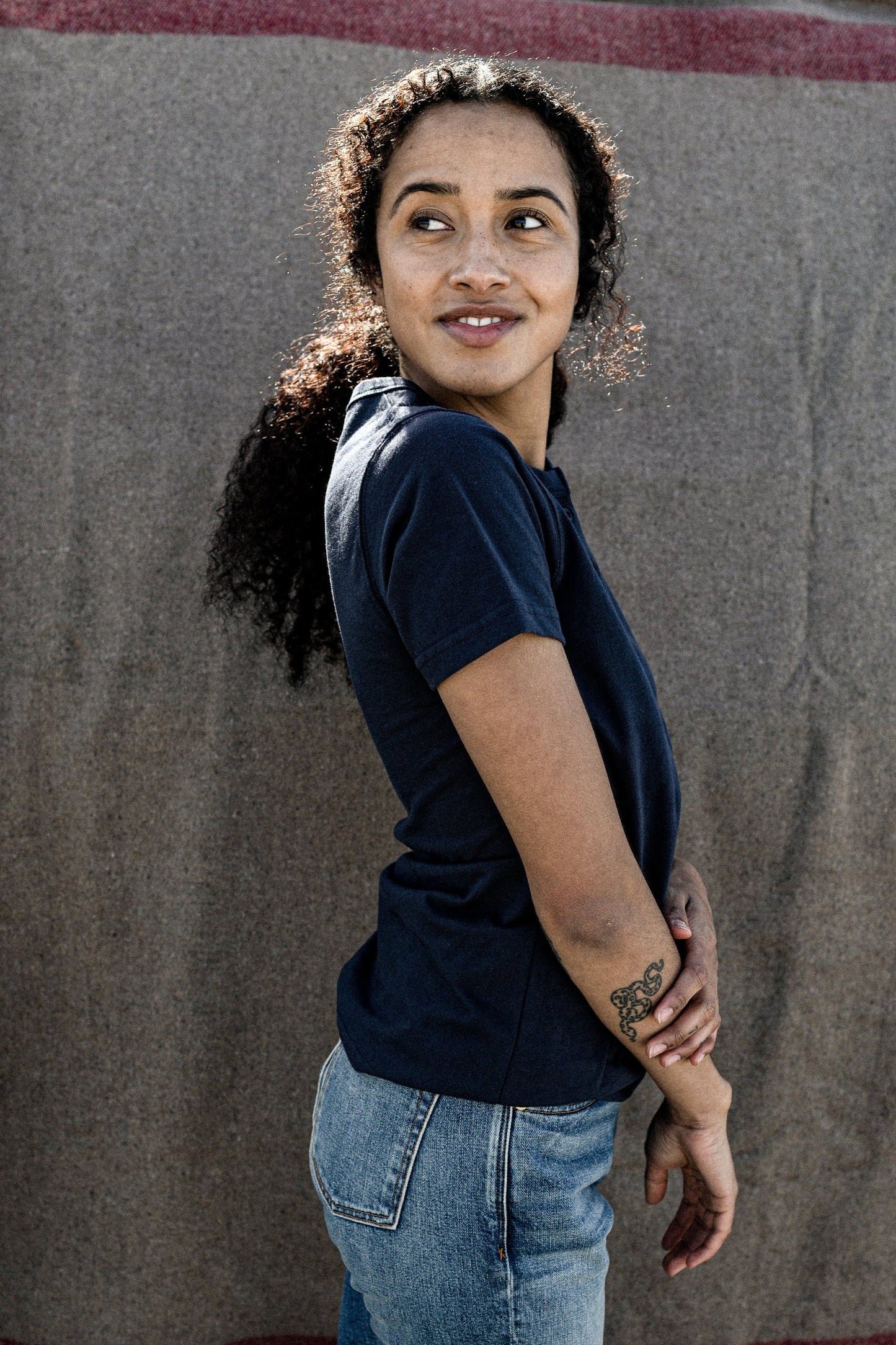 woman turning back with a tee