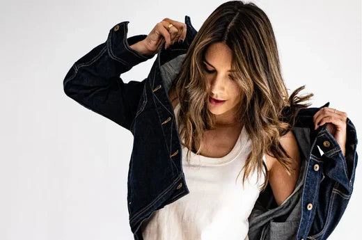 Custom clothing production denim jacket worn by a woman, featuring durable fabric and timeless style.