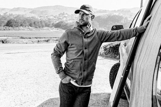 French terry clothing featuring a stylish button-up hoodie worn by a man leaning against a vehicle in an outdoor setting