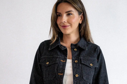 High-end denim fashion showcased by a woman in a dark denim jacket and matching pants