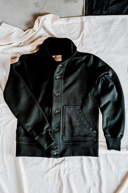 Men's basalt French terry cardigan laid flat, showing the shawl collar, button-front closure, and patch pockets