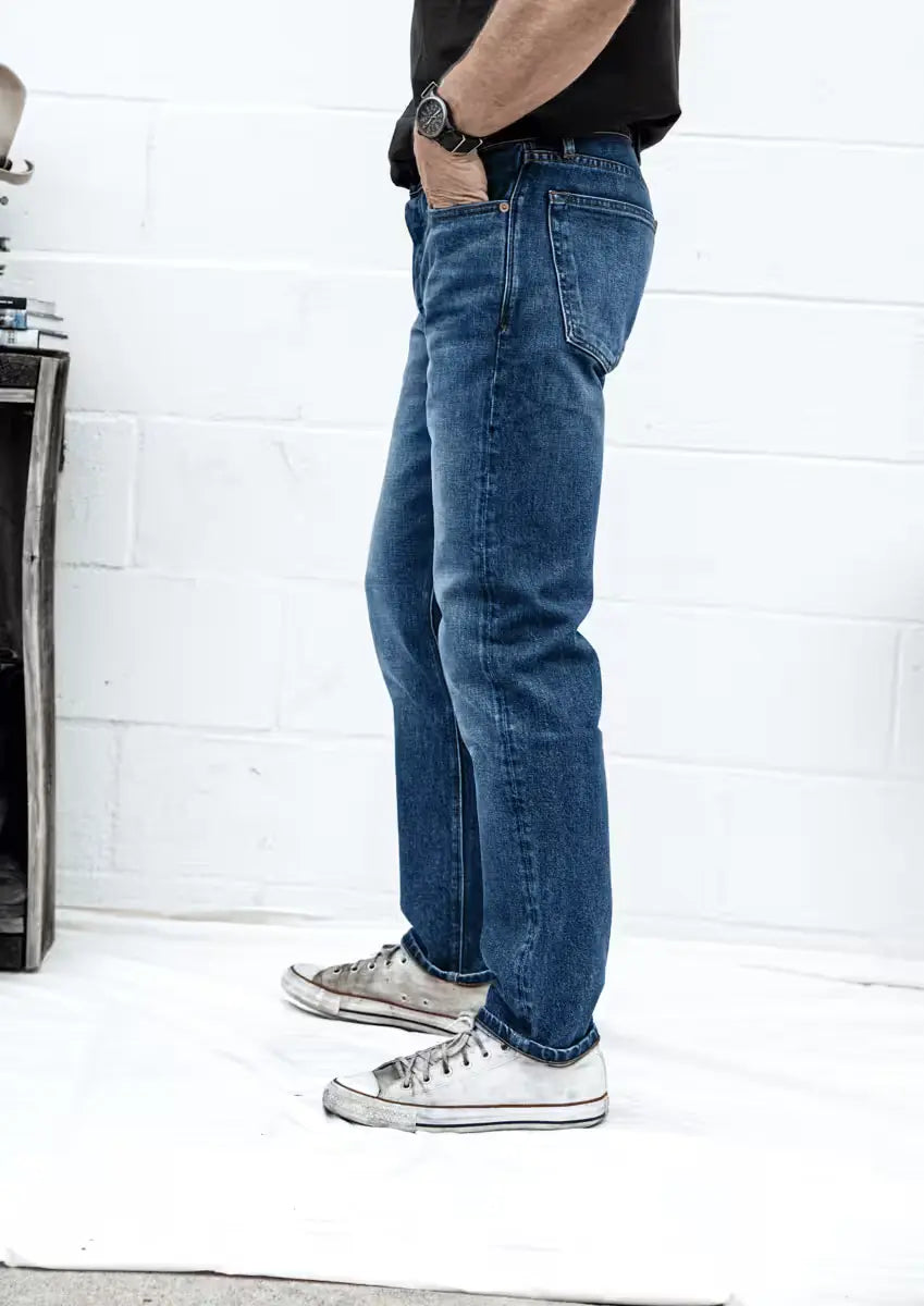 Man wearing a Sam Fit jeans in River Wash color featuring a classic straight-leg cut & detailed stitching