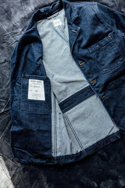 Interior flat lay of a men's ocean denim chore blazer showing the striped lining and inside chest pocket