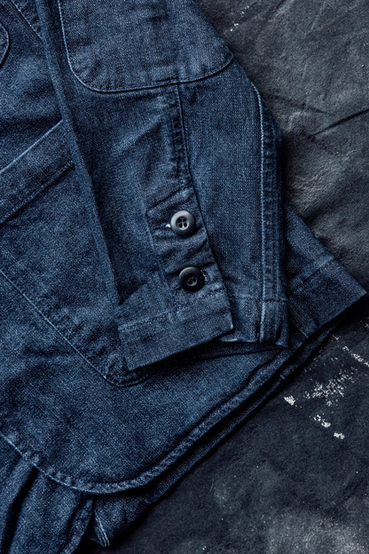 Close-up of the button cuff and sleeve hem detail on a men's ocean denim chore blazer