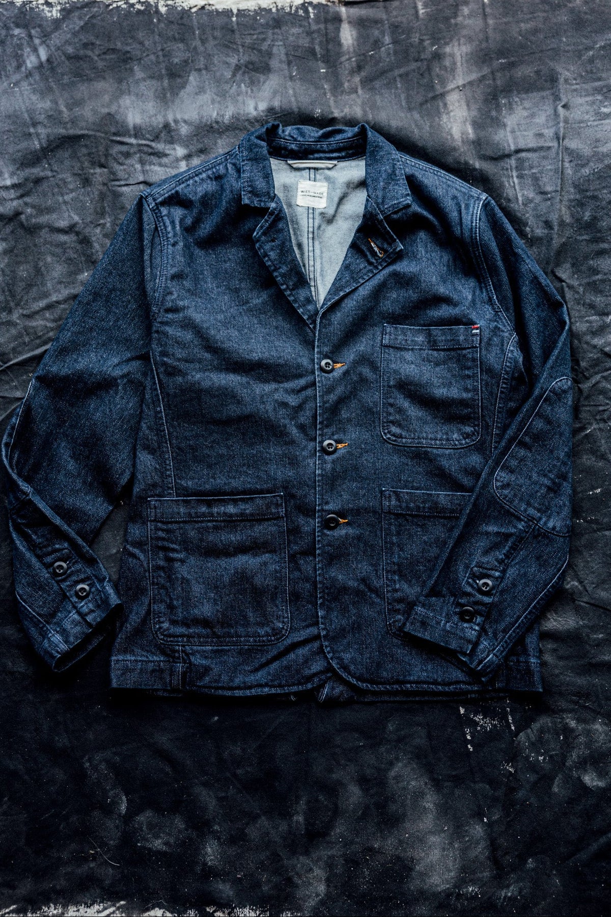 Flat lay of a men's ocean denim chore blazer with button-front closure and four patch pockets