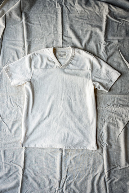 Flat lay of a men's natural heather V-neck cotton jersey top with short sleeves