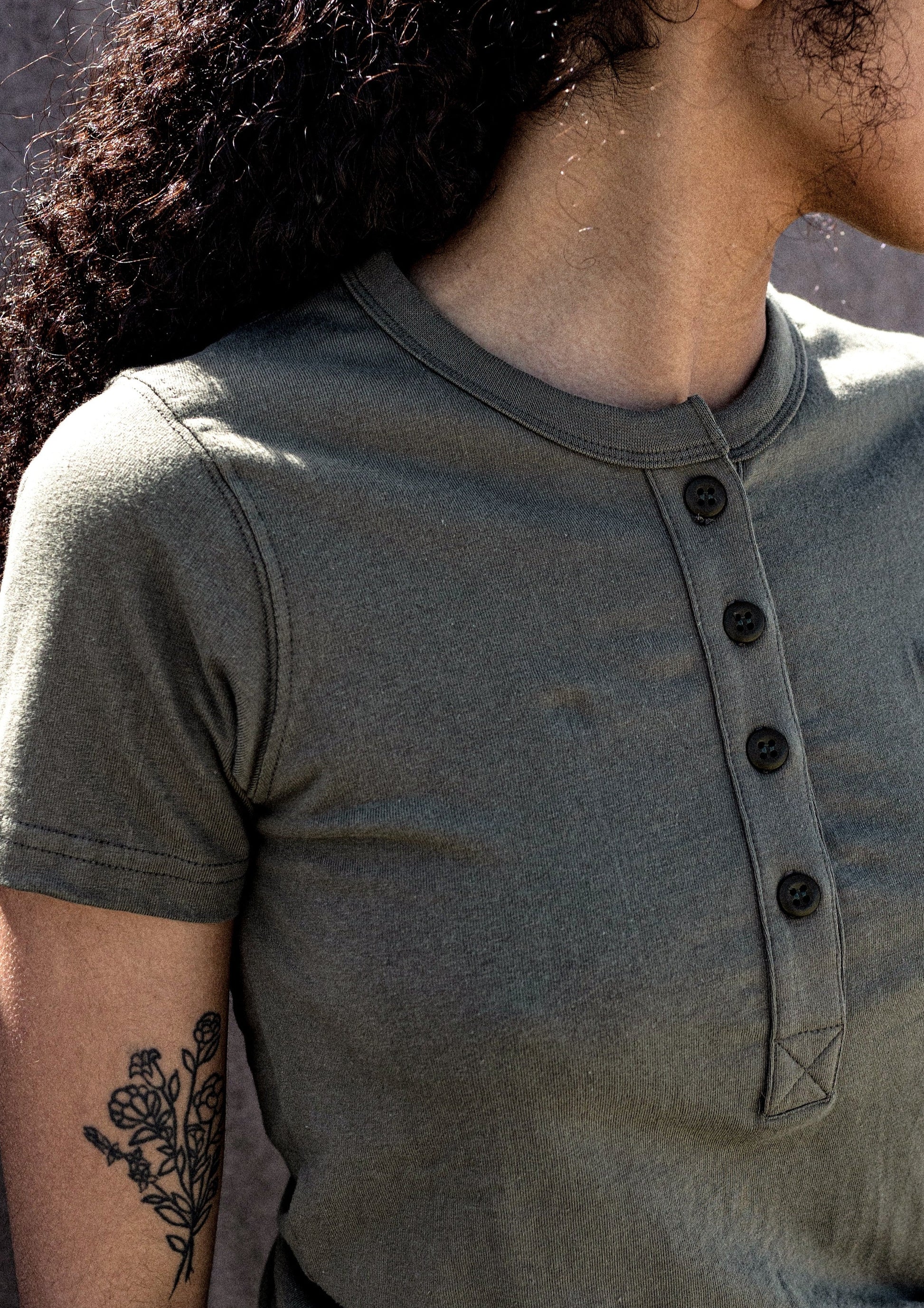 close up of a woman wearing henley olive