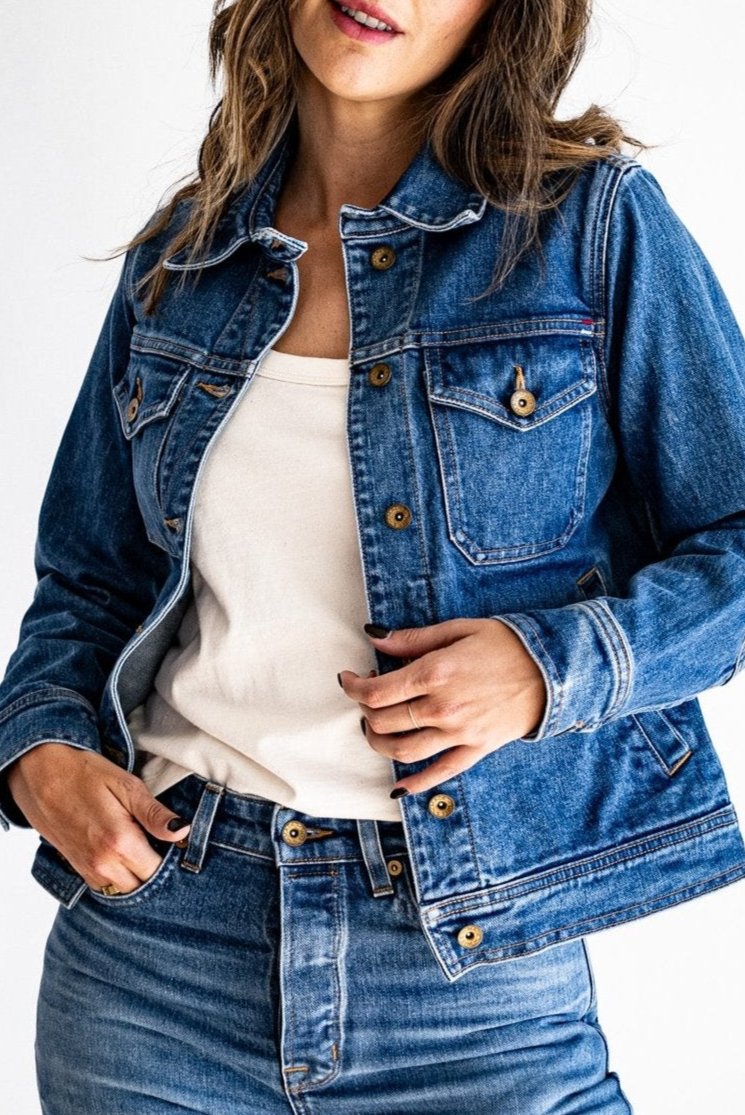 USA made denim jacket styled with a white shirt and high-waisted jeans, modeled against a white background.
