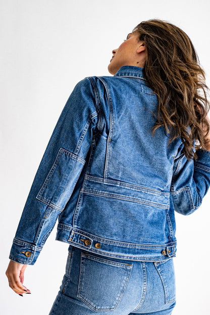USA made denim jacket shown from the back, paired with high-waisted jeans against a bright white background.