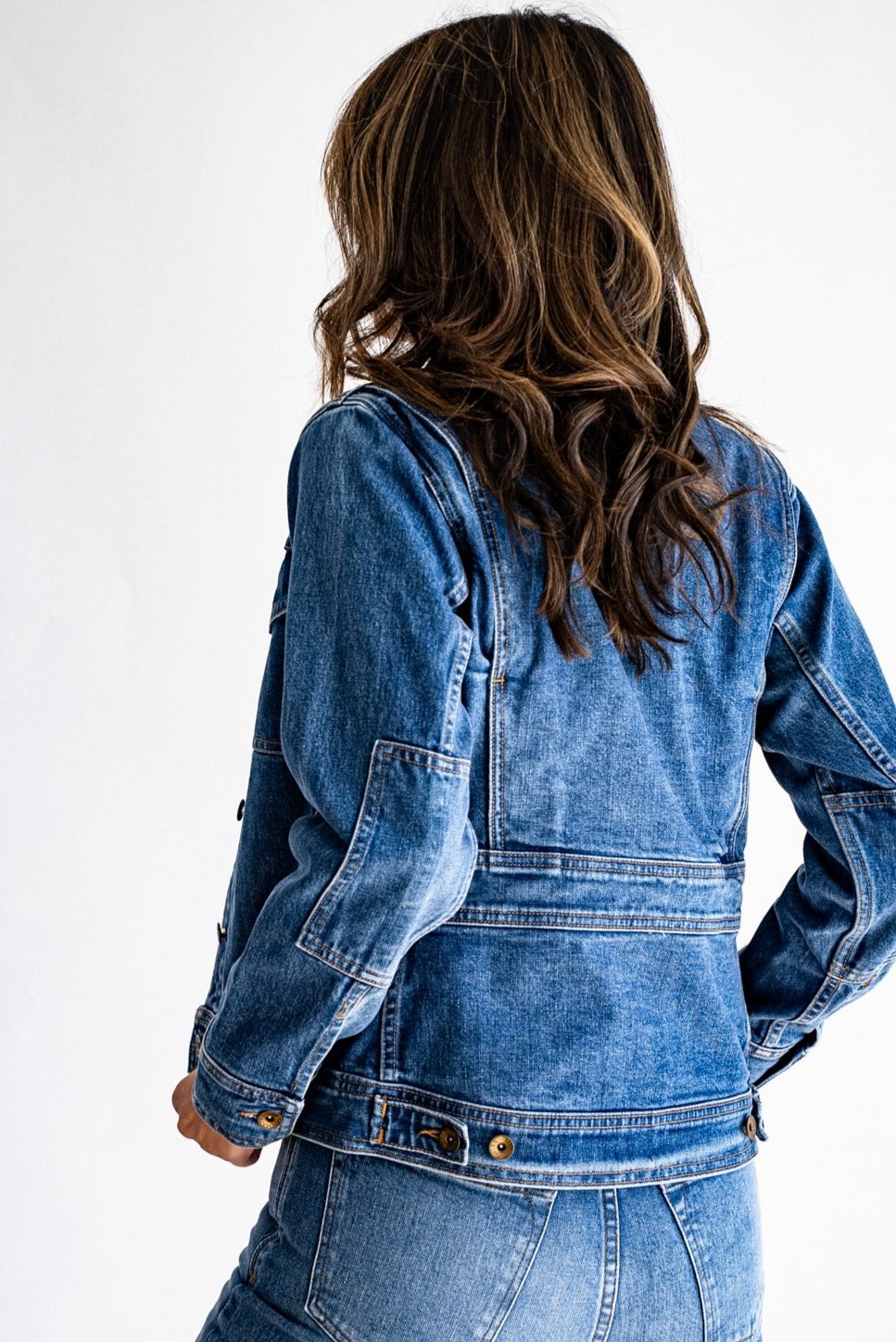 Denim jacket made in USA paired with matching jeans, shown from the back against a white background.