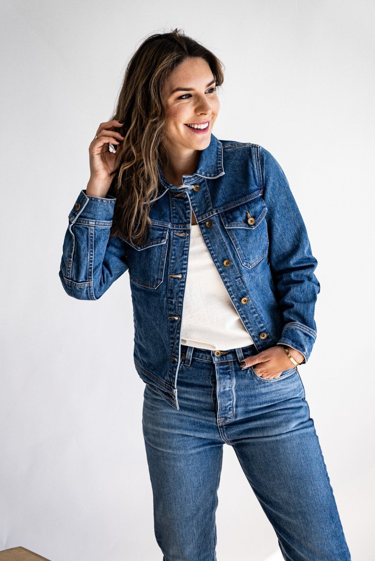 USA made denim jacket styled with matching high-waisted jeans and a white shirt, modeled against a white background.