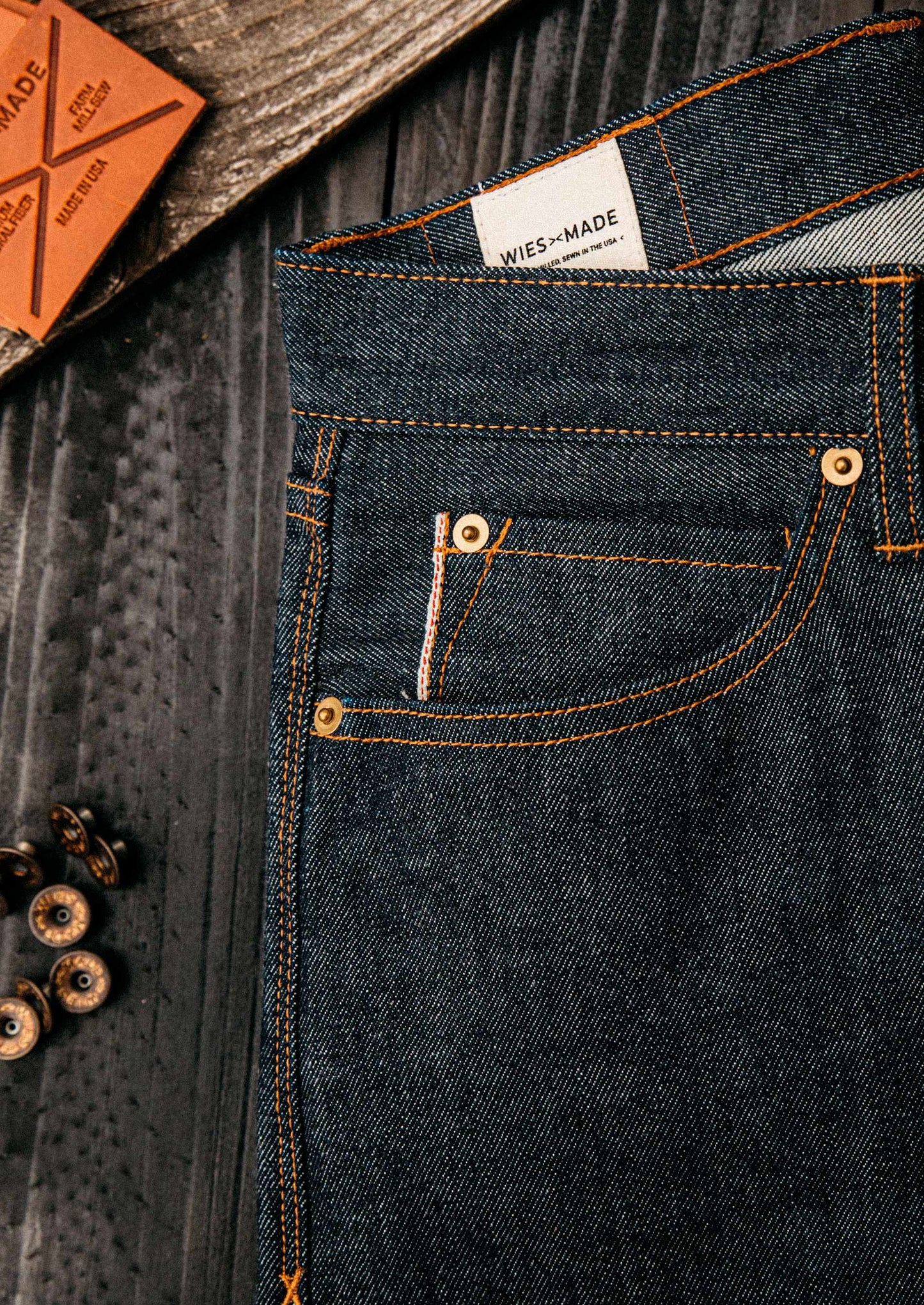close up photo of denim jeans and loose buttons next to it
